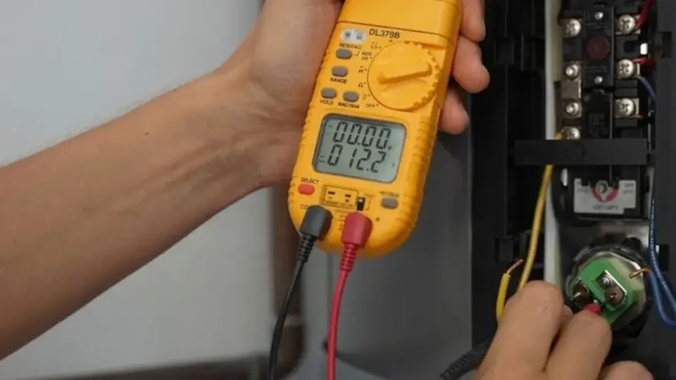 Technician testing the electrical connections on a water heater with a multimeter